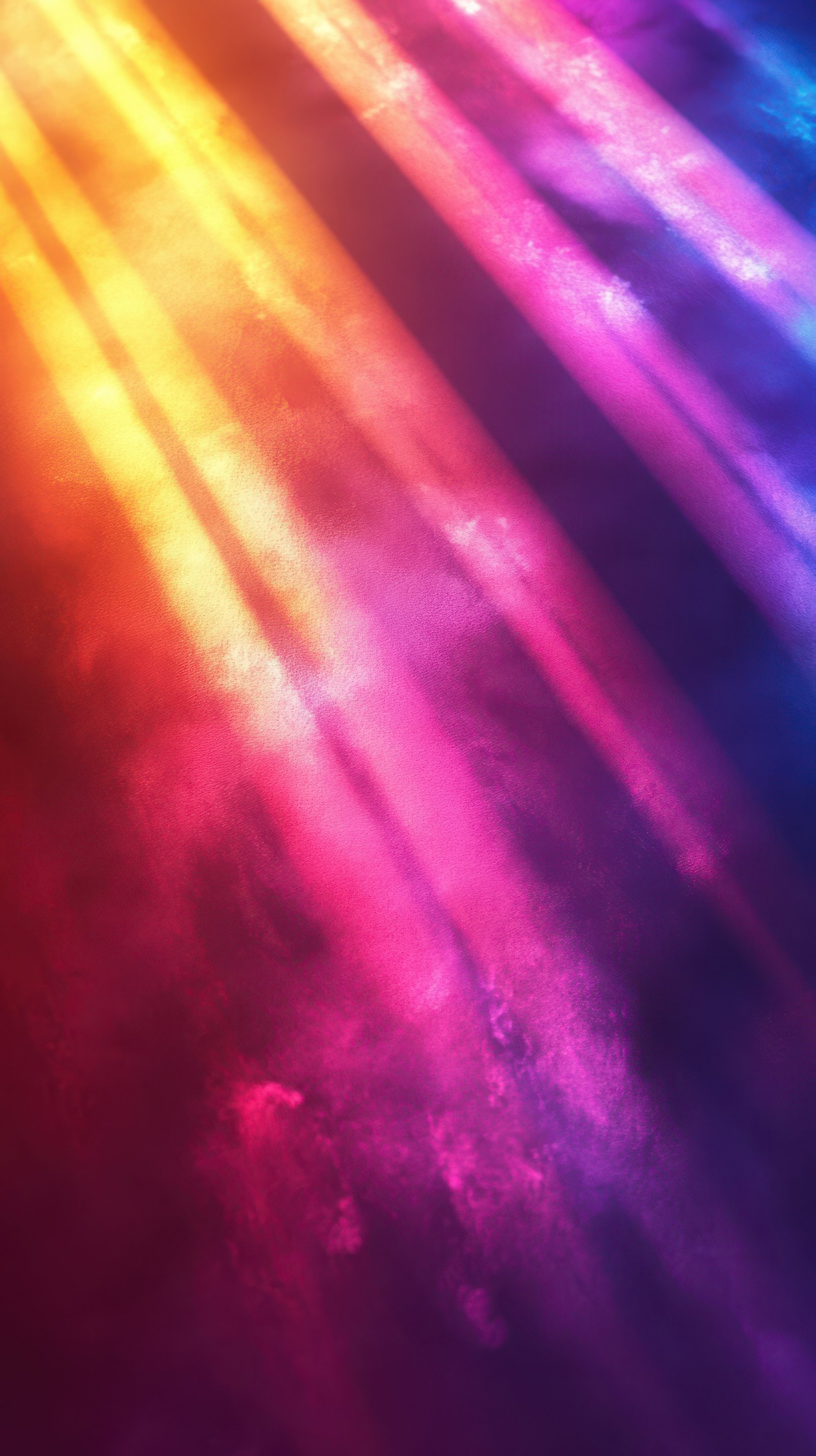 Vibrant rays of colorful light illuminate a dark background creating an abstract visual experience